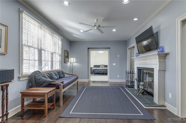 living room featuring ornamental molding, ceiling fan, and dark wood-type flooring