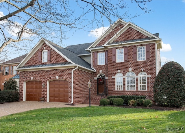 view of front of property featuring a front lawn and a garage