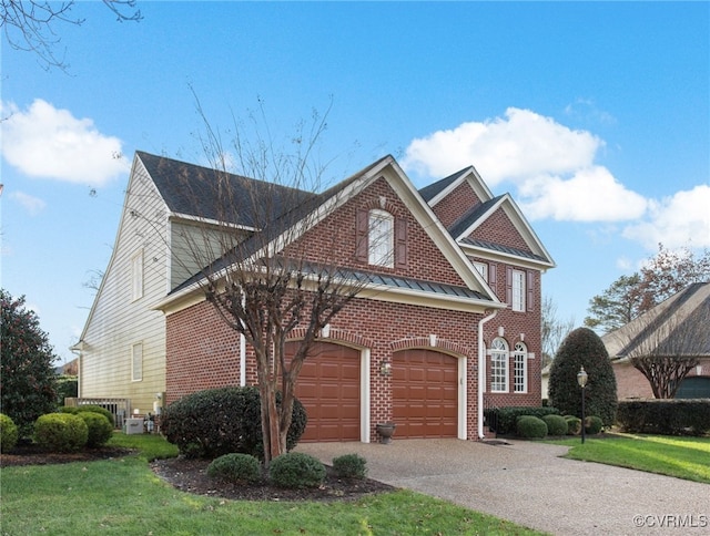 view of front of house featuring a front yard and a garage