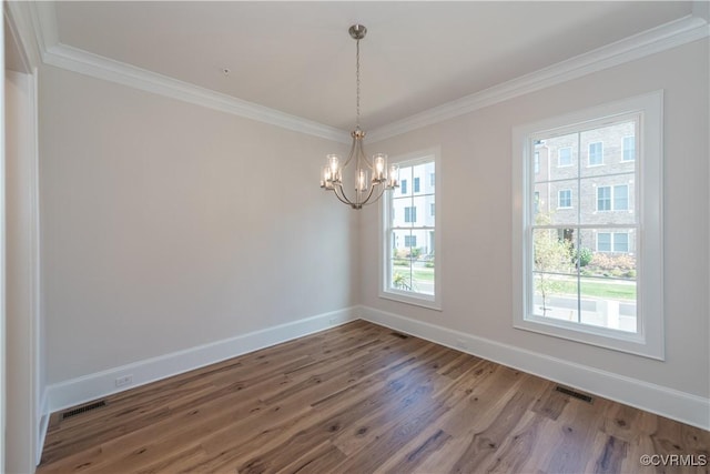 unfurnished room featuring hardwood / wood-style flooring, plenty of natural light, and crown molding