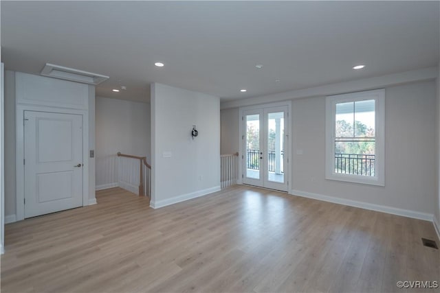 unfurnished room with french doors and light wood-type flooring