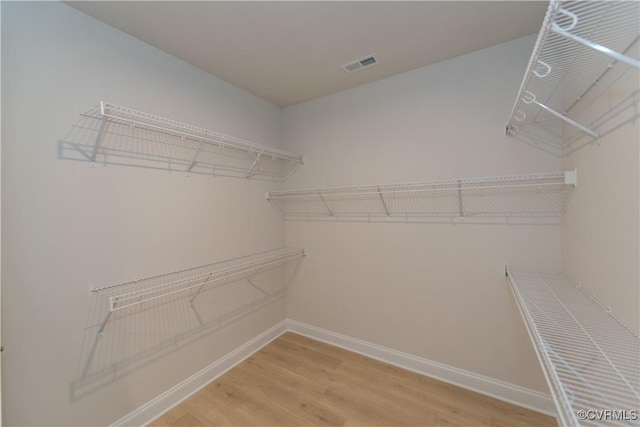 spacious closet featuring hardwood / wood-style floors