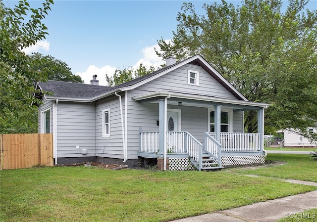 view of front facade featuring covered porch and a front yard