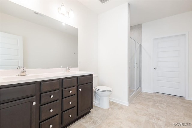 bathroom featuring vanity, an enclosed shower, and toilet