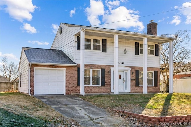 view of front of house with a front yard, a porch, and a garage