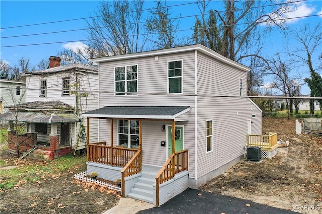 view of front of property with a porch and central air condition unit