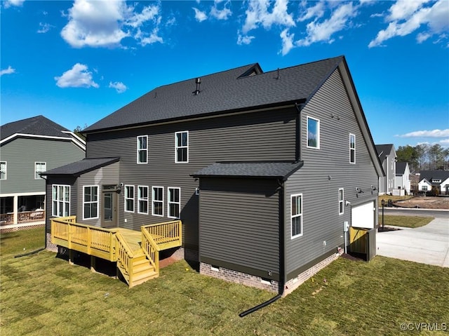 back of property with a garage, a wooden deck, and a yard