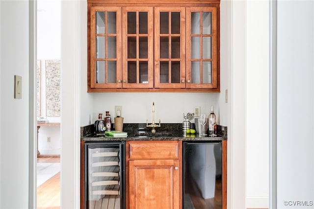 bar featuring sink, wine cooler, black fridge, hardwood / wood-style floors, and dark stone counters