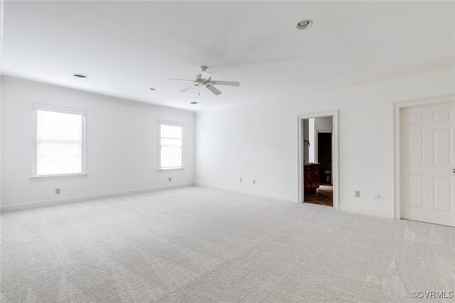 carpeted empty room featuring crown molding and ceiling fan