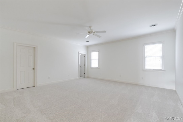 empty room with light carpet, ceiling fan, and crown molding