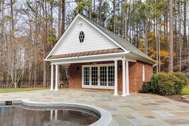 exterior space featuring a fenced in pool and french doors