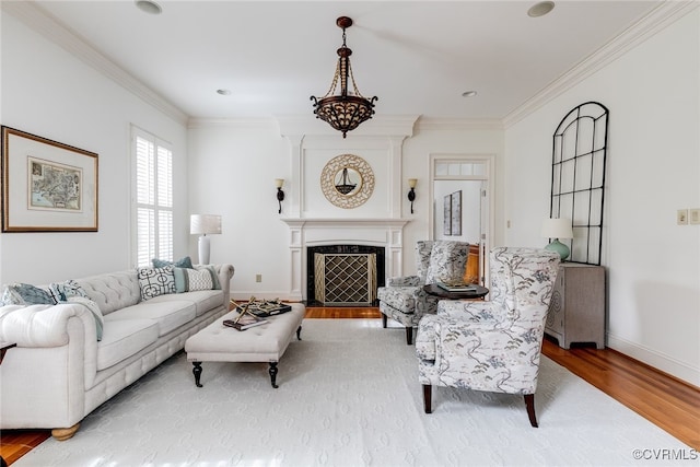 living room featuring light hardwood / wood-style floors and ornamental molding