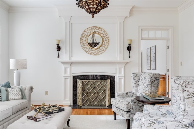 living room with crown molding, a fireplace, and wood-type flooring