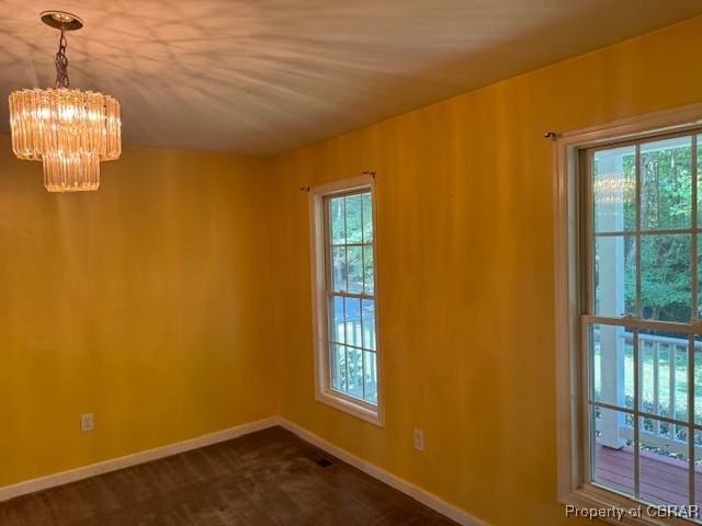 spare room with an inviting chandelier and a healthy amount of sunlight