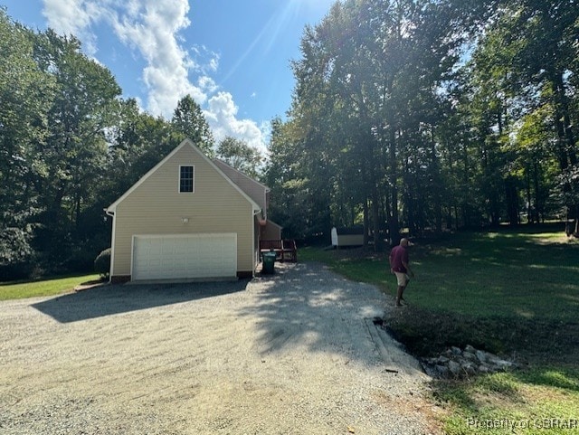 view of property exterior featuring a garage and an outbuilding