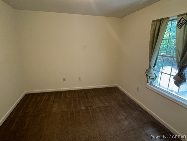 carpeted empty room featuring plenty of natural light