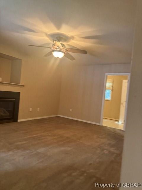 unfurnished living room with ceiling fan