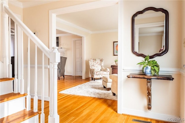 living area featuring crown molding and hardwood / wood-style floors