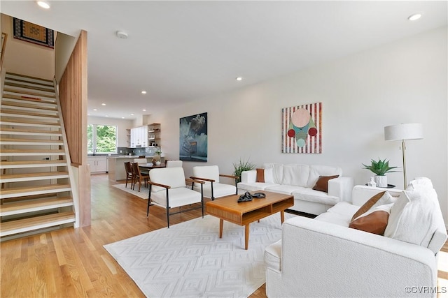 living room featuring light hardwood / wood-style flooring and sink