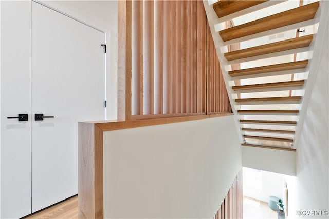 stairway featuring hardwood / wood-style flooring