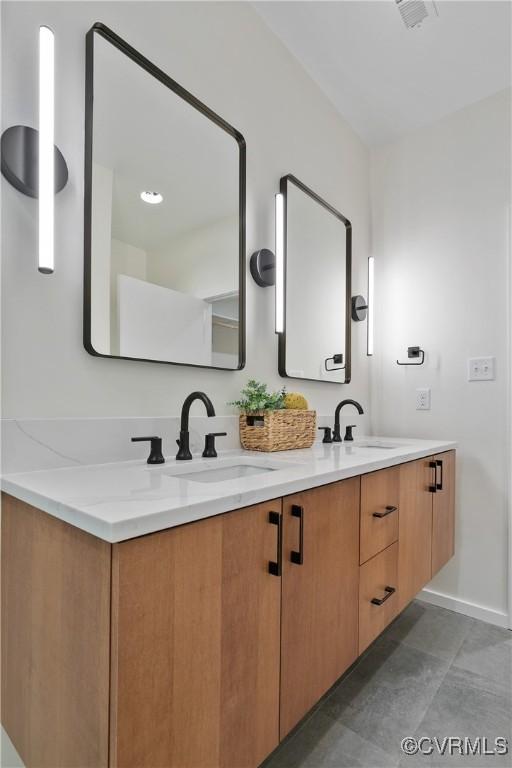 bathroom featuring tile patterned flooring and vanity