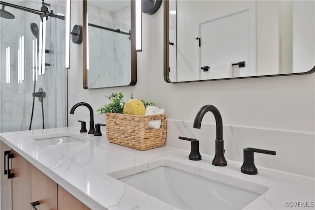 bathroom featuring vanity and an enclosed shower