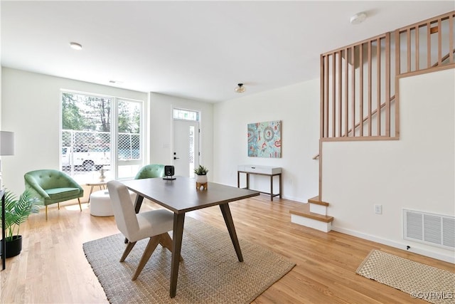 dining space with hardwood / wood-style floors