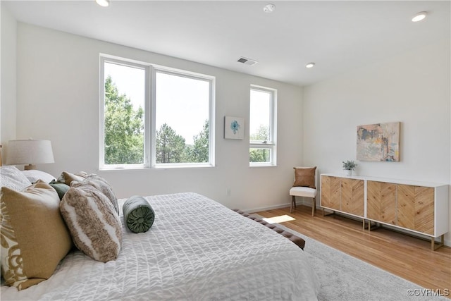 bedroom featuring hardwood / wood-style flooring and multiple windows