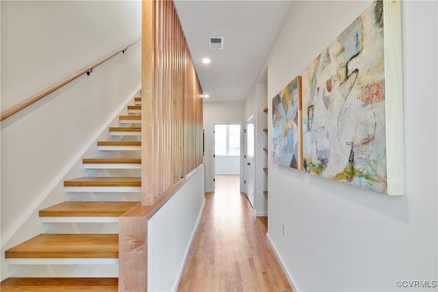 corridor with light hardwood / wood-style floors