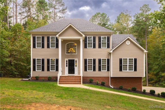 colonial inspired home with a front yard