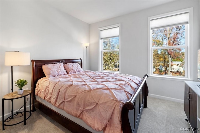 carpeted bedroom featuring multiple windows