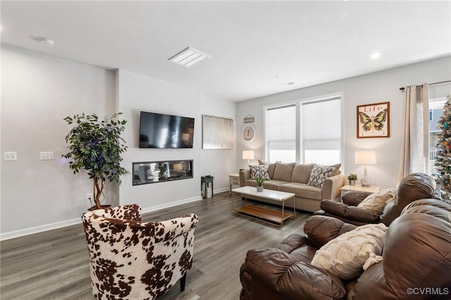 living room featuring a healthy amount of sunlight and dark hardwood / wood-style floors