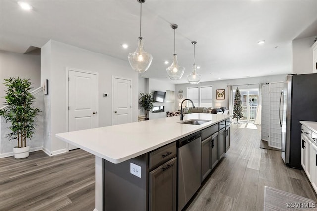 kitchen with white cabinets, dark hardwood / wood-style floors, sink, and appliances with stainless steel finishes