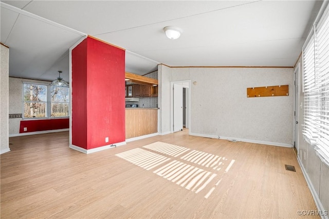 interior space with ornamental molding, hardwood / wood-style flooring, and lofted ceiling