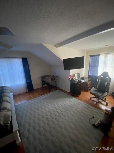 interior space with vaulted ceiling, dark hardwood / wood-style flooring, and a textured ceiling