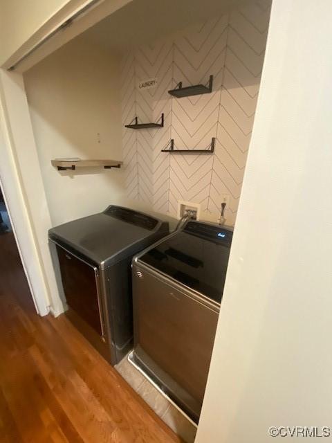 laundry area featuring dark hardwood / wood-style flooring and washer and clothes dryer