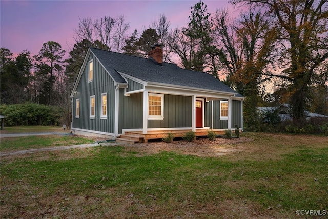 view of front of property featuring a lawn and covered porch