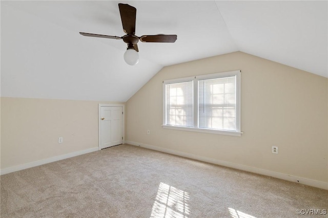 additional living space with light carpet, ceiling fan, and lofted ceiling