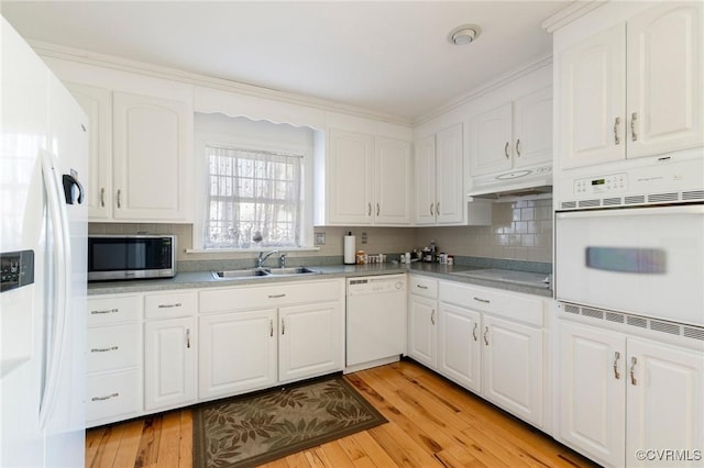 kitchen featuring white cabinets, light wood-type flooring, white appliances, and sink