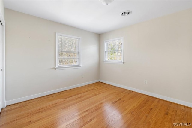 unfurnished room with light wood-type flooring