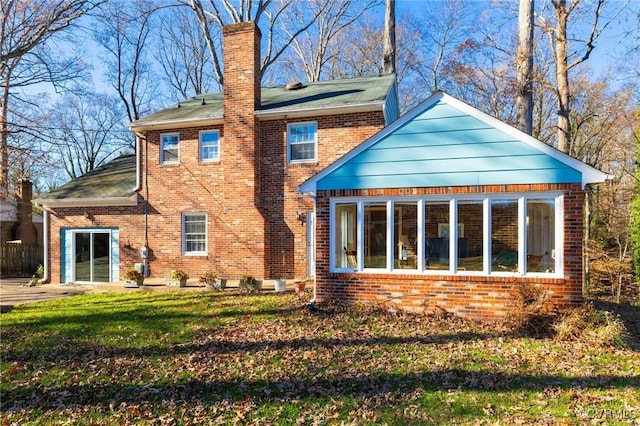 back of house featuring a yard