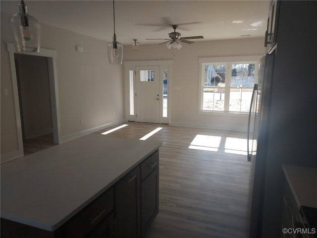 interior space featuring ceiling fan, dark hardwood / wood-style flooring, and decorative light fixtures