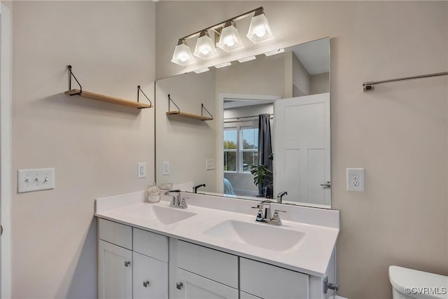 bathroom with vanity and toilet