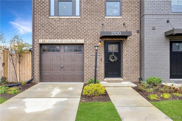 doorway to property with a garage