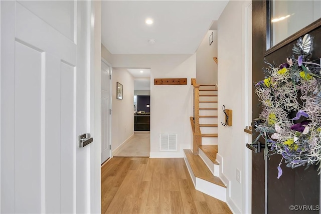 hallway with light hardwood / wood-style flooring