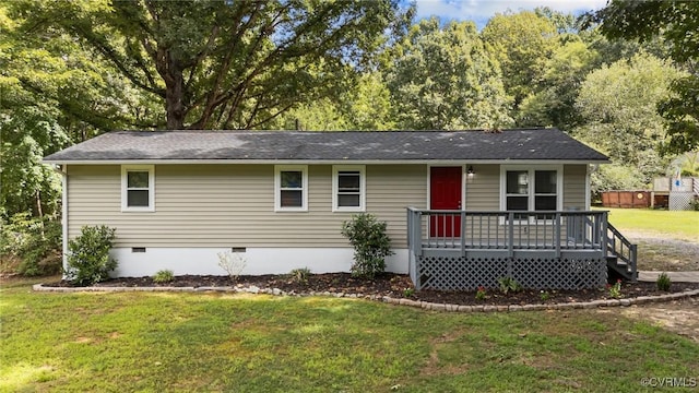 ranch-style home featuring a front yard and a deck