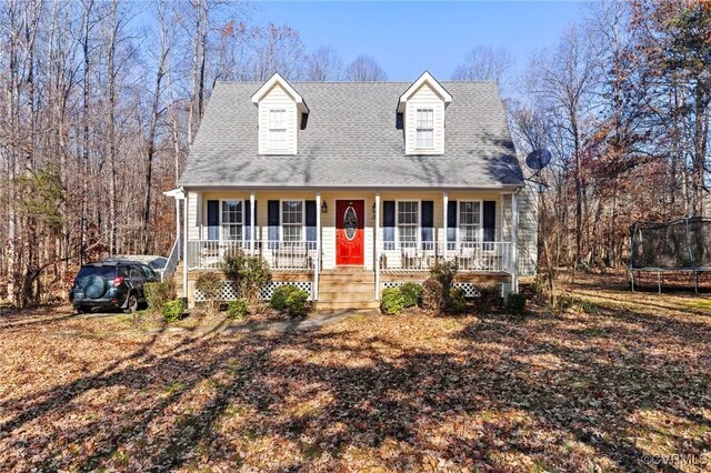 new england style home featuring a porch and a trampoline