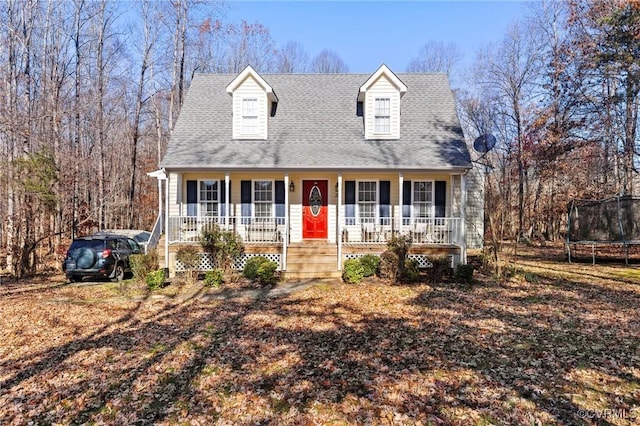 new england style home with a trampoline and covered porch