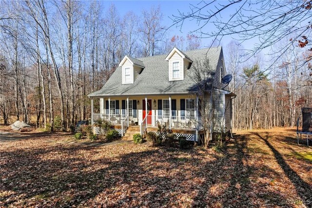 cape cod home featuring a porch and a trampoline