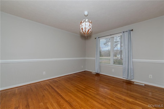 10710 Courthouse Rd, Dinwiddie, VA 23841 - spare room featuring wood-type flooring and a textured ceiling